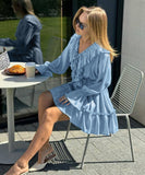 Elegant V-Neck White Dress with Flared Sleeves and Ruffled Details
